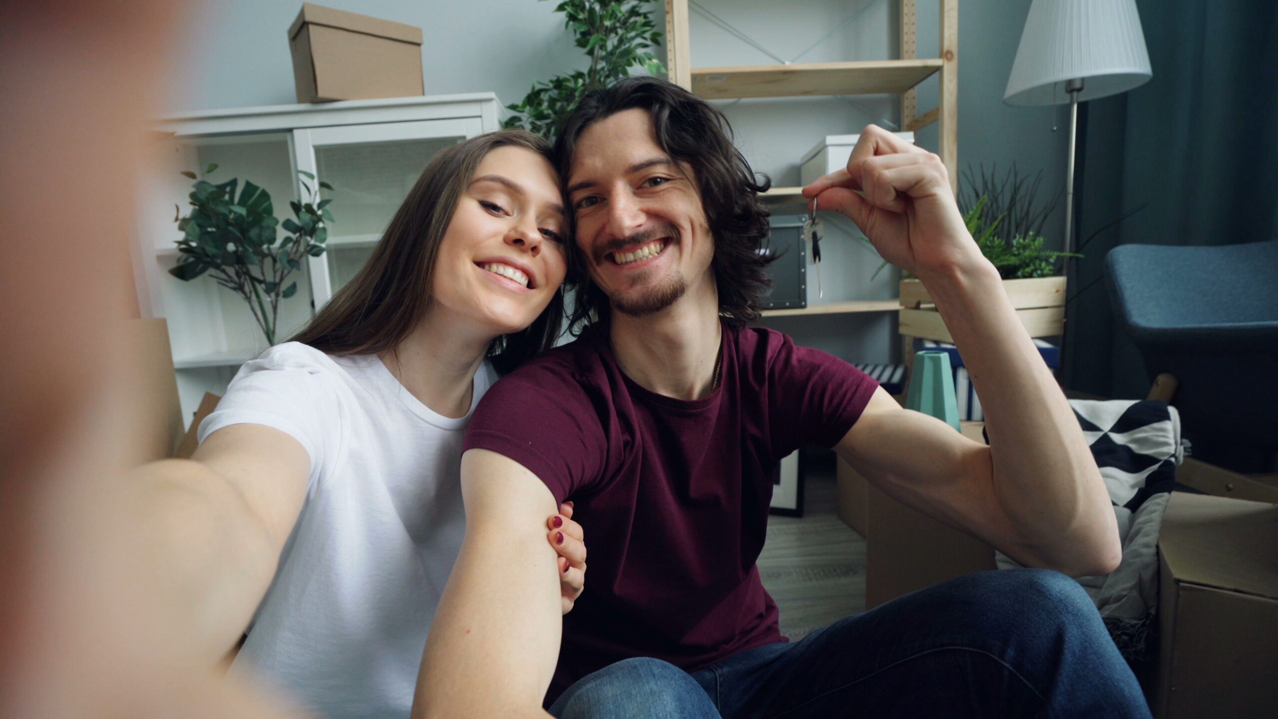New homeowners holding the keys to their first home